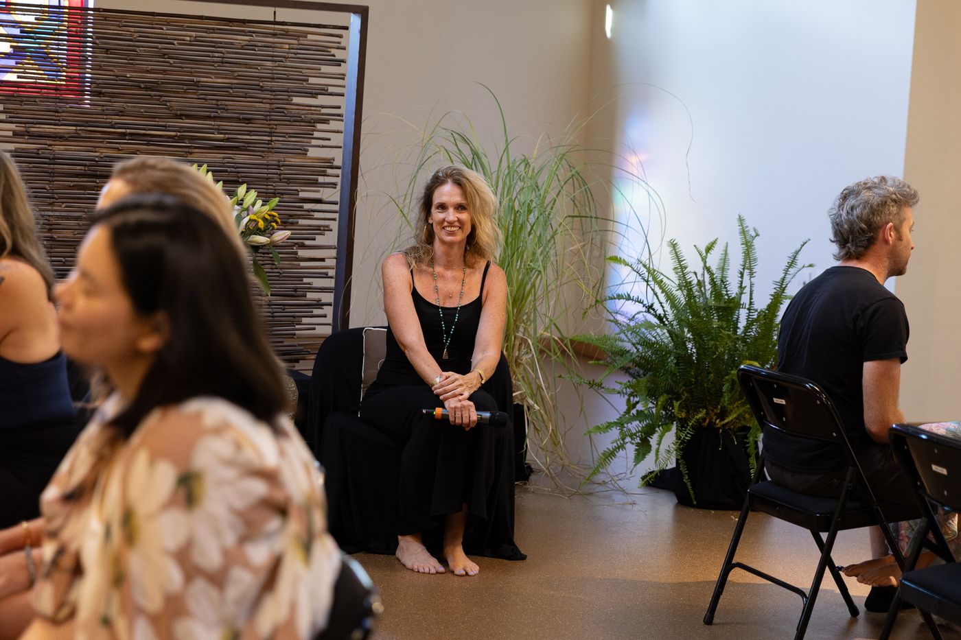Option C: Sarah standing among seated participants.