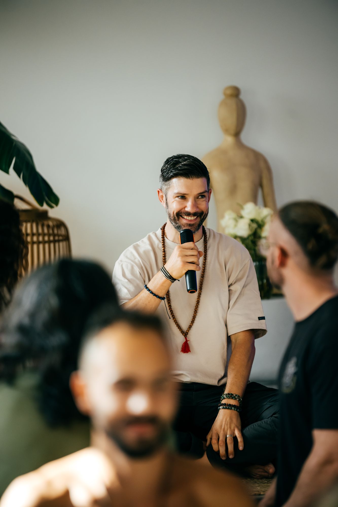 Portrait of Travis Streb speaking with a microphone.