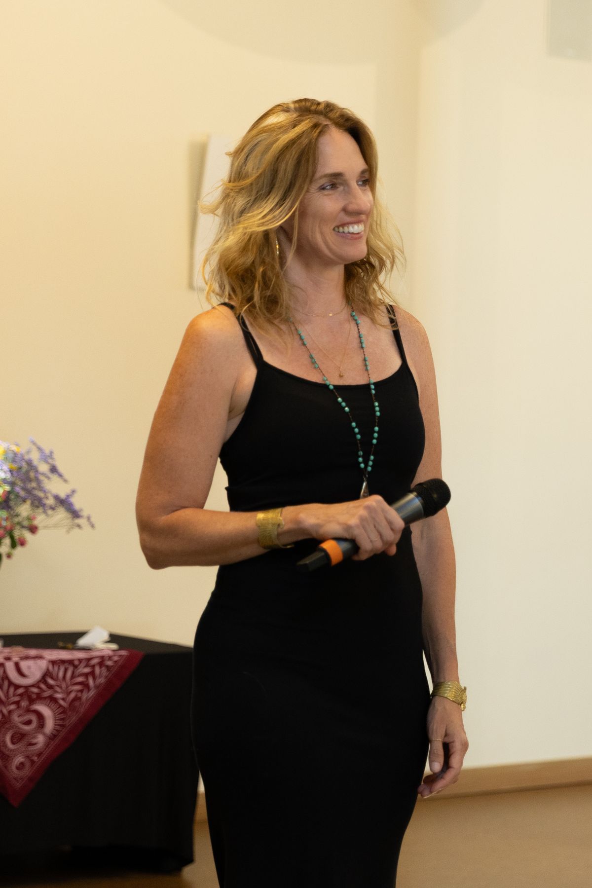 Option A, on the page now: Sarah smiling with a microphone in the workshop room.